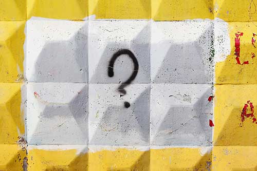 Stock image of a question-mark against textured background